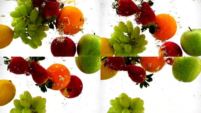 苹果，猕猴桃，橙子，梨，柠檬，葡萄和草莓落入水中，并带有气泡。慢动作录像