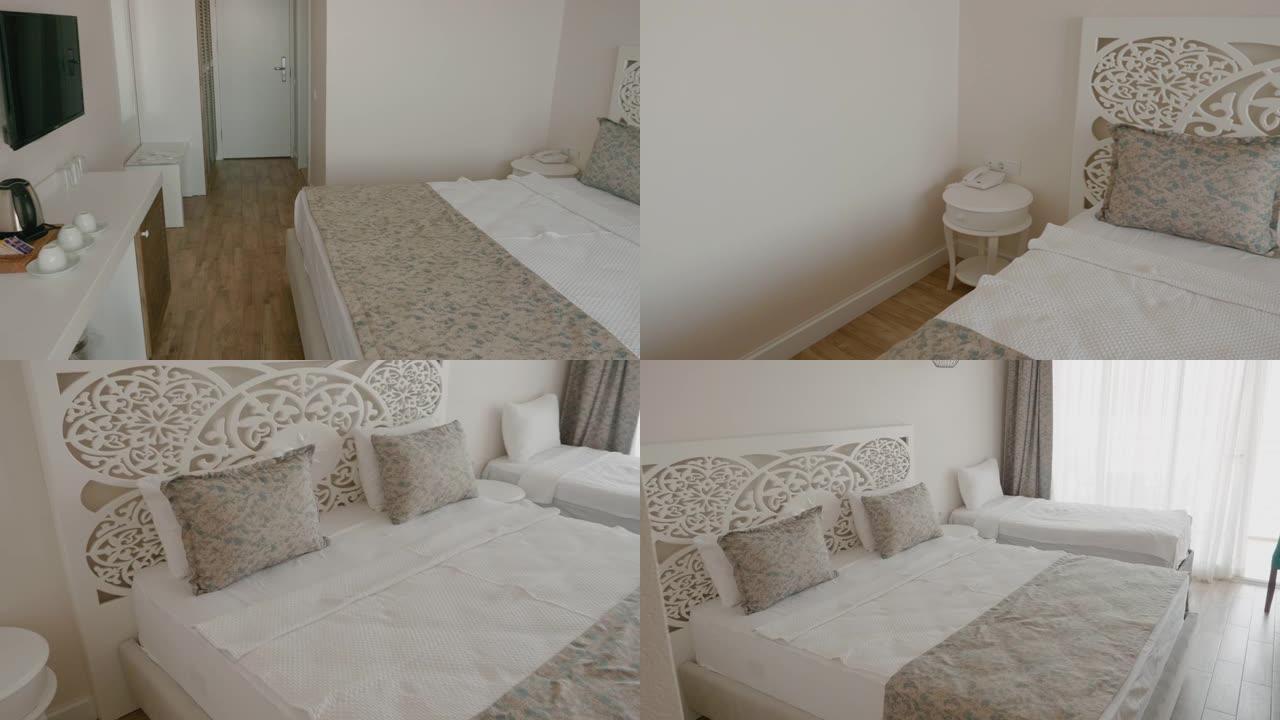 豪华度假酒店的室内白色卧室。舒适卧室的双人床和单人床。白色室内装饰和酒店三人时尚卧室家具。