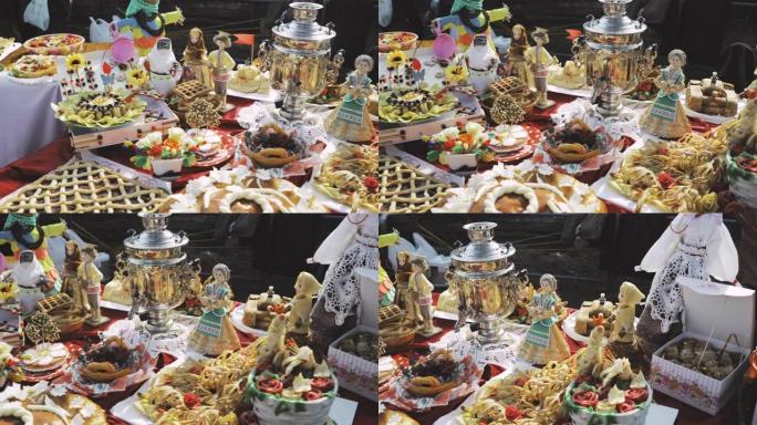 甜糕点和俄罗斯茶炊。桌子上有糖果、煎饼和馅饼。庆祝活动中的传统俄罗斯茶饮用国家传统节日Masleni