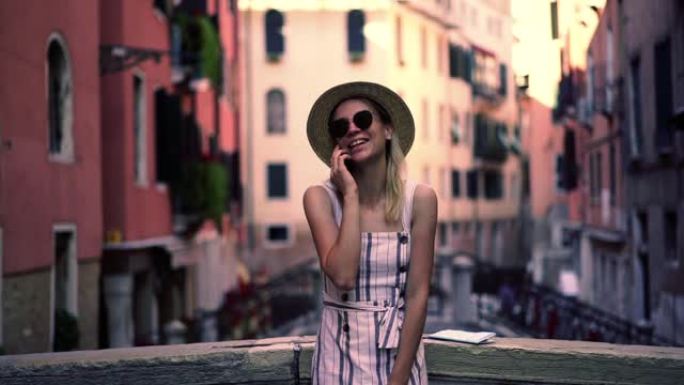 戴着时尚帽子和太阳镜的快乐微笑女人享受通过移动应用程序与朋友交谈的时间连接到4g互联网漫游