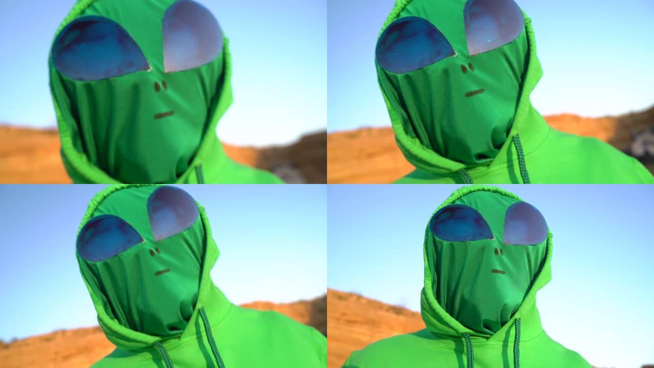 一名男子穿着绿色的外星人狂欢节服装套装大笑