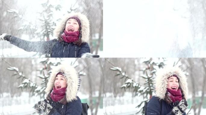美丽的年轻女孩用手扔雪，积极表达喜悦，笑着拍手。