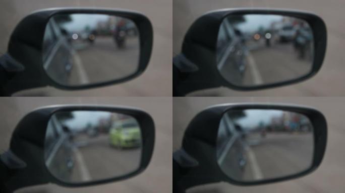 侧视镜特写，车辆在路上模糊。