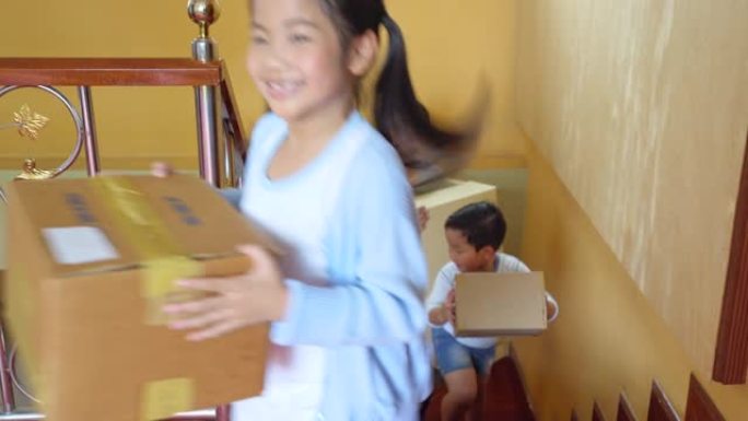 亚洲家庭生活方式拿着箱子进家，纸箱和布置房子