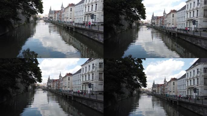 比利时根特-2019年5月: 城市水渠景观。游艇停泊在居民楼附近。在市中心的泊位。