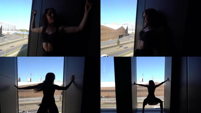 专业舞者在窗前跳舞。