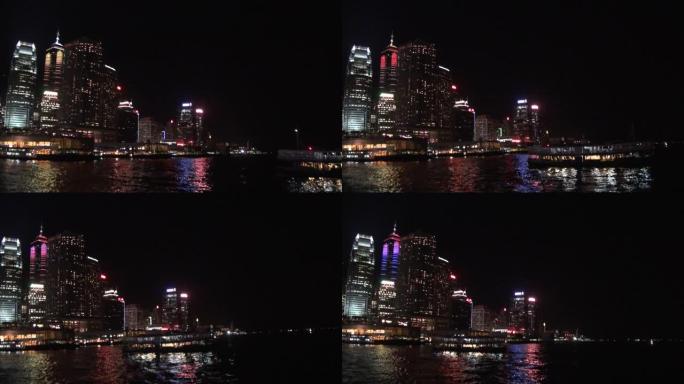 维多利亚港渡轮的香港天际线夜城