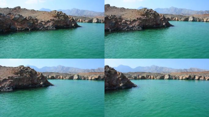 阿曼穆桑达姆的绿色水域在中东进行的Dhow船之旅中，峡湾，落基山脉和霍尔木兹海峡附近的蓝水