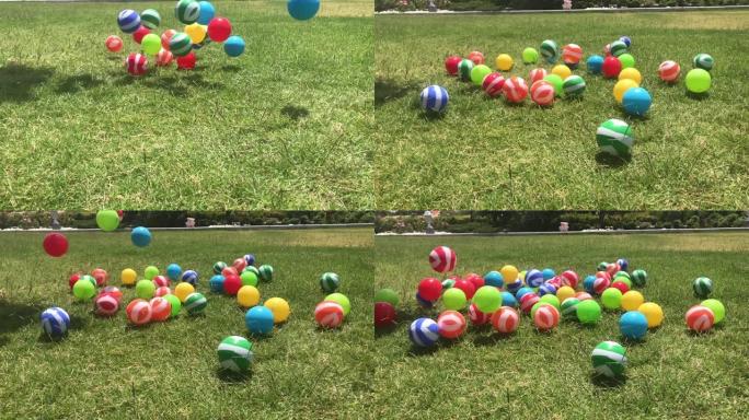 五颜六色的球在花园里弹跳