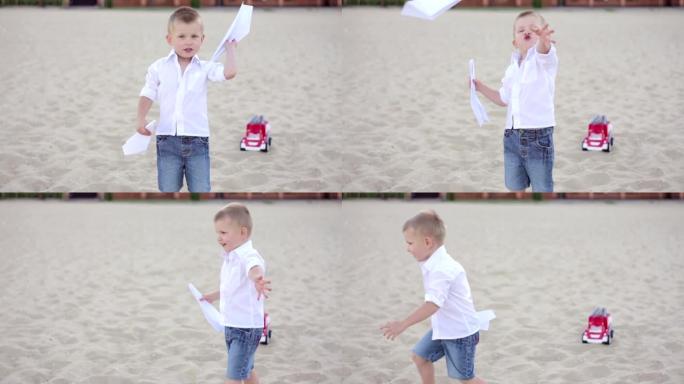 一个孩子在海滩上发射纸飞机