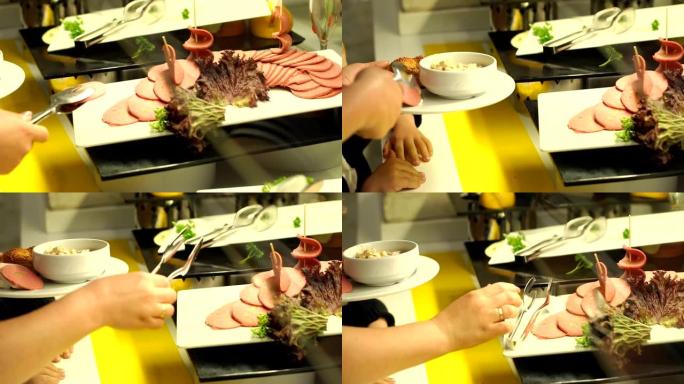 一个用钳子的女孩的特写镜头要切成薄片的香肠。餐饮自助餐。