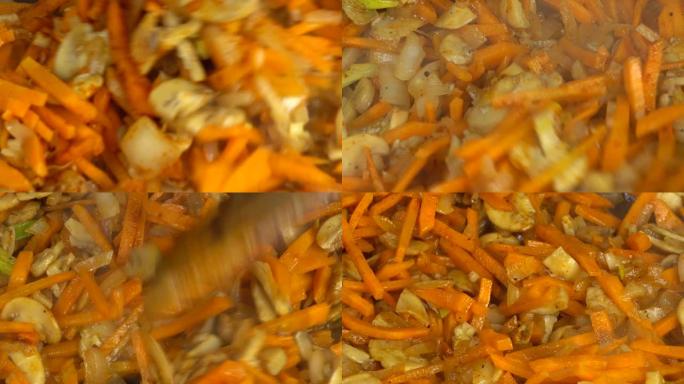 用洋葱和胡萝卜制备香菇。铸铁锅。