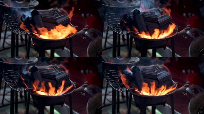 关闭泰国曼谷的慢动作街头美食厨师，通过在煤气炉上燃烧木炭作为烧烤菜单来准备食物。
