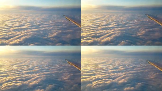 美丽的紫罗兰色和白云的鸟瞰图，在灿烂的日落中像丘陵的雪，从飞行的飞机上飞来的天幕