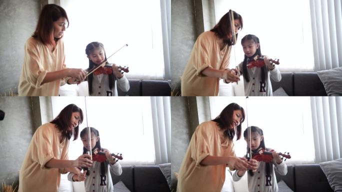 女人教小女孩如何拉小提琴