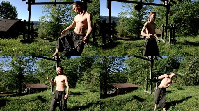 中等长镜头早晨训练一个长发男子参加火灾表演。在一个阳光明媚的夏天早晨，准备一场没有火的表演，用火把和