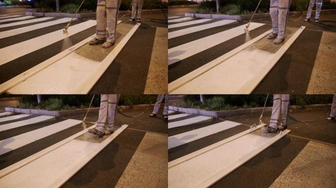 路面标记人员在黄昏时重新粉刷斑马线