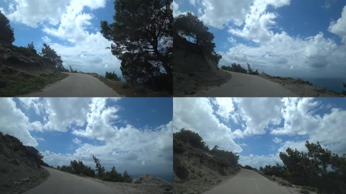 视点射击。汽车沿着海边陡峭的狭窄道路爬到山上，从汽车上可以看到。