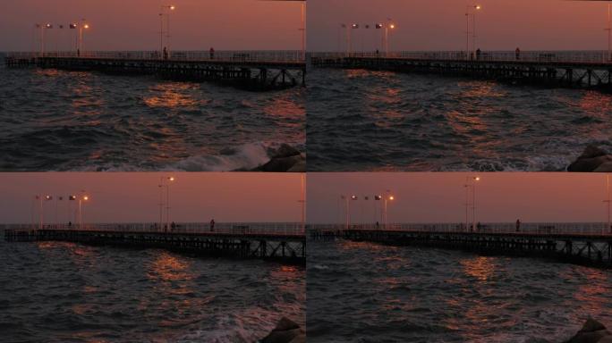 塞浦路斯利马索尔海岸码头，晚上有渔民和游客，地中海灯笼的光线反射得很漂亮