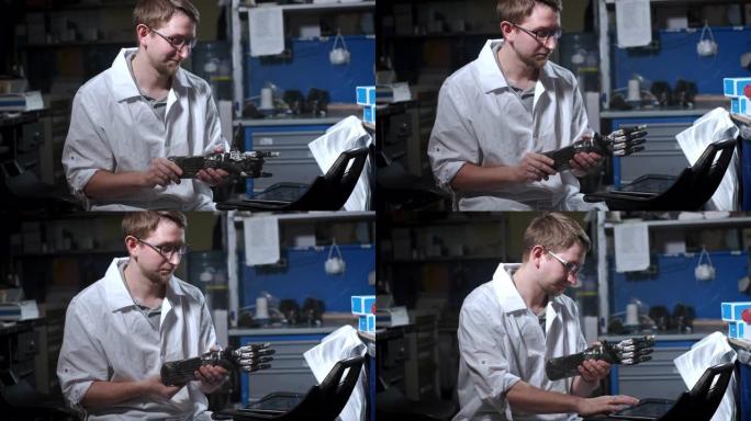 一位科学家工程师正在测试电子仿生假肢。他移动机械臂的塑料手指。假肢的现代技术。科学家手中的控制论手