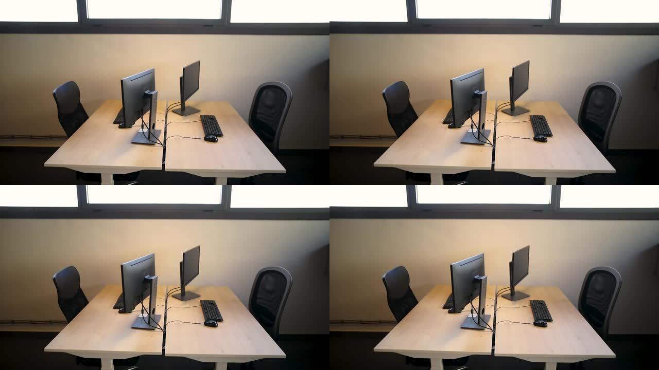 开放式计划办公室，配有工作站和计算机。现代办公室内配有桌椅，宽敞的工作环境