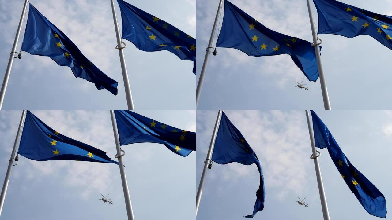 一面欧盟旗帜，背景是一架警用直升机。慢动作看起来很有象征意义