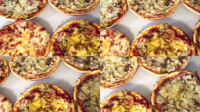白色背景上的披萨，六种不同类型的披萨。蘑菇，香肠，火腿，奶酪。