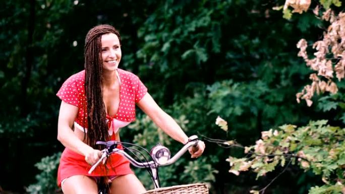 自行车。一个女人骑自行车穿过森林。