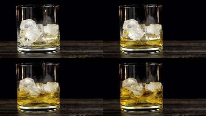 威士忌被倒入加冰的玻璃杯中