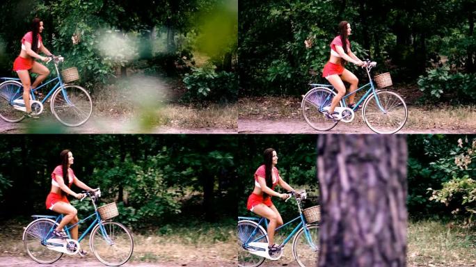 自行车。一个女人骑自行车穿过森林。