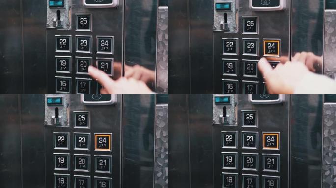 女性手按下面板上24层的按钮进入电梯轿厢