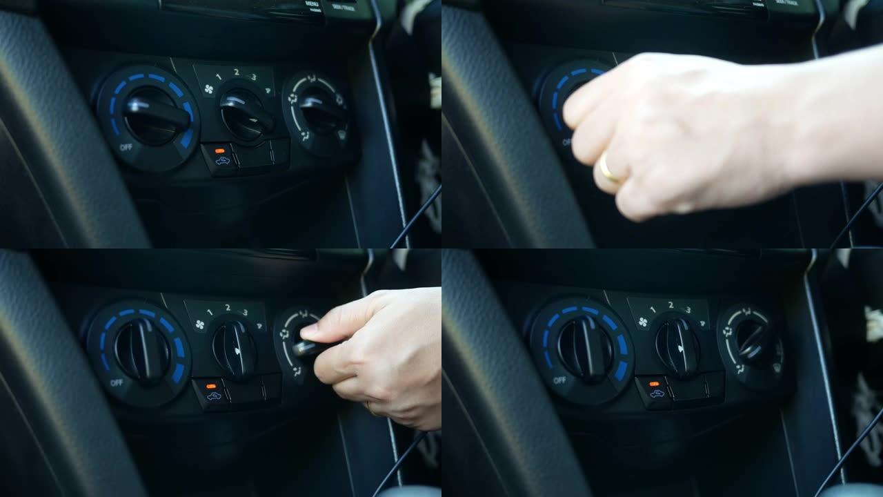 关闭驾驶员的手调节汽车空调和通风系统与风扇速度选择器旋钮在汽车。技术和运输概念。