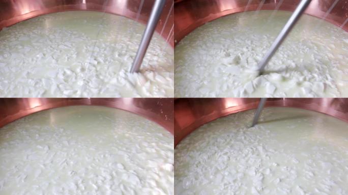 农民在加热山羊奶时混合山羊奶以生产奶酪的特写镜头