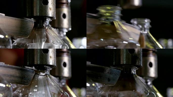 圆形金属喷嘴的特写镜头上下弹起，并在葵花籽油生产厂的输送机上移动的空瓶中倒油。