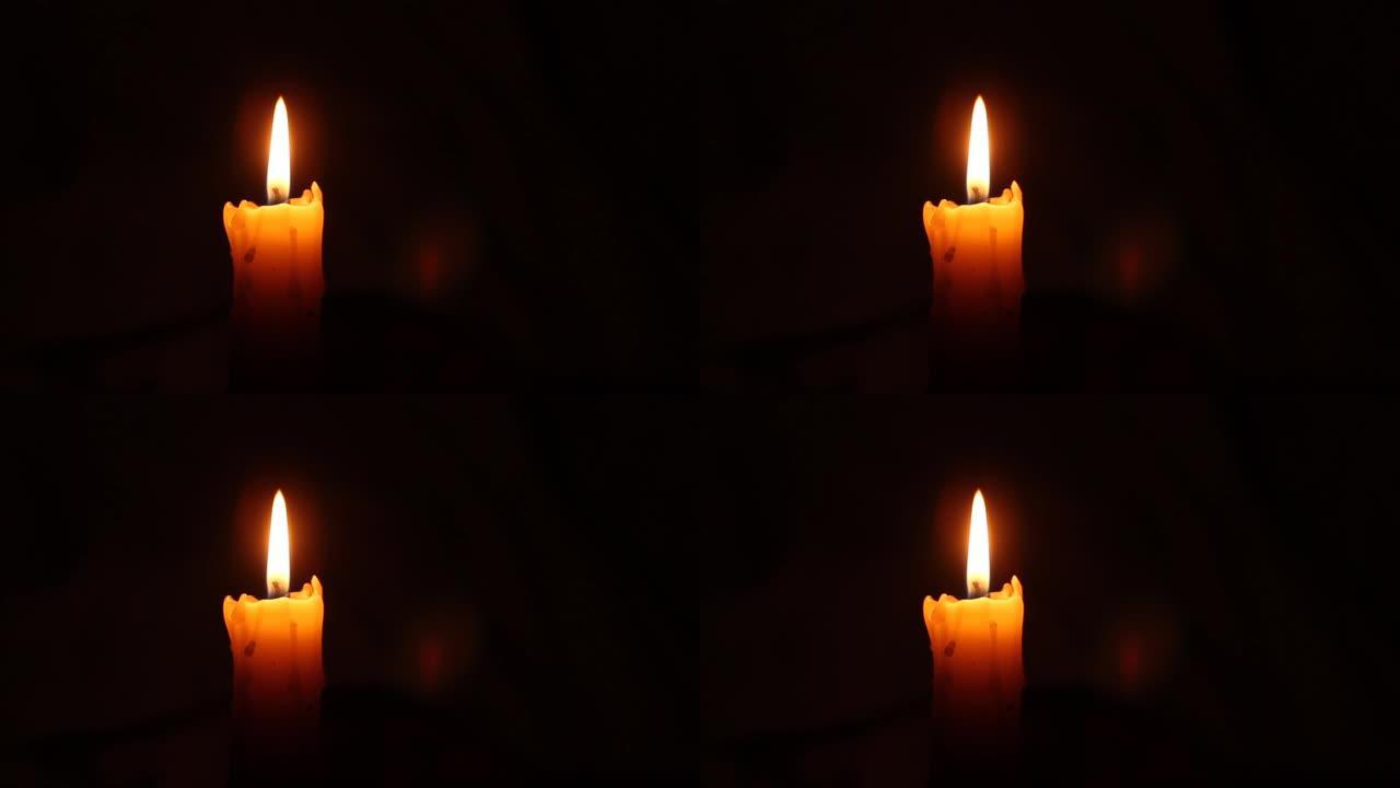 黑色蜡烛火焰特写。旧白色蜡烛