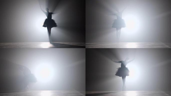 芭蕾舞女演员在剧院发光的霓虹灯聚光灯下，穿着芭蕾舞短裙的独奏表演。穿着足尖鞋跳舞古典动作的女人的剪影