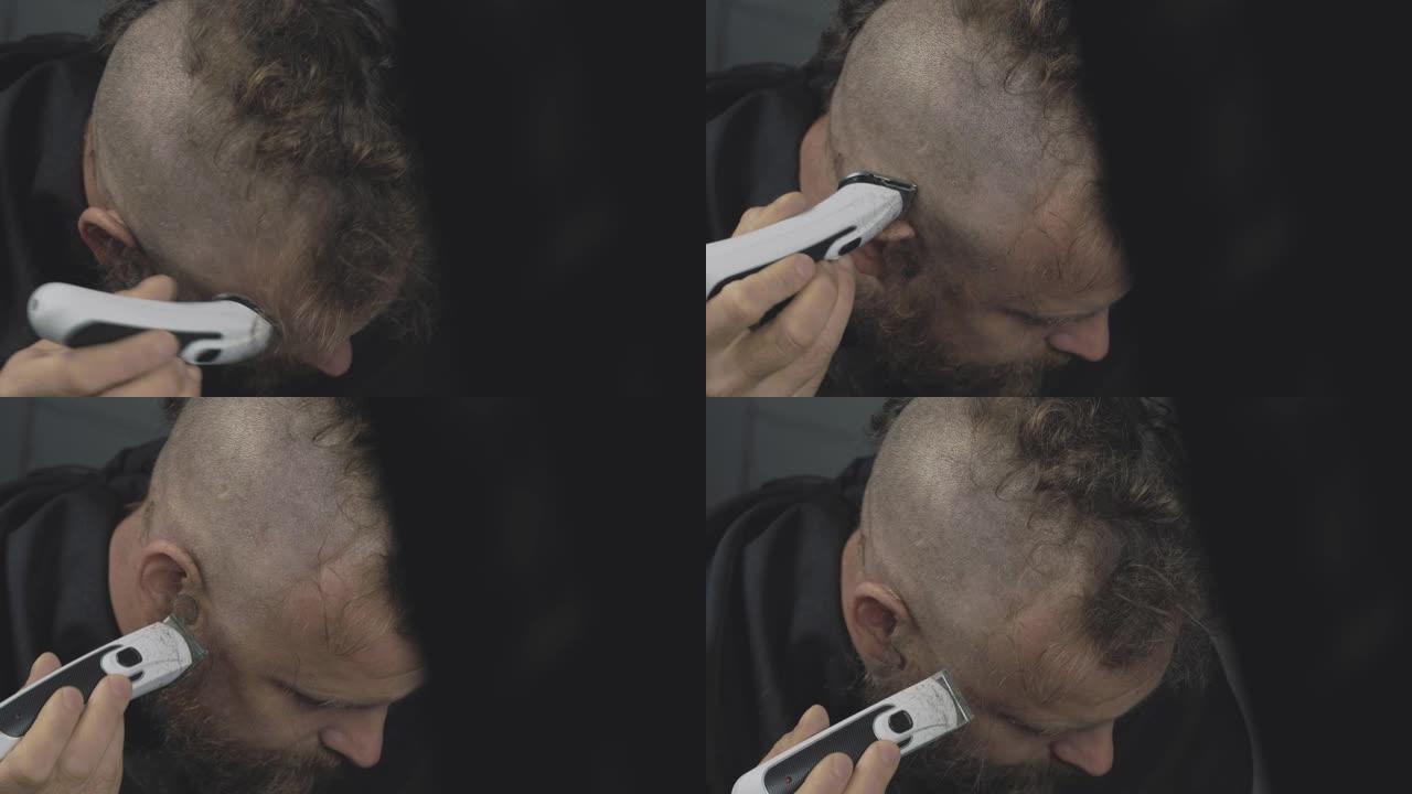 一个留着胡须的男人用电动修剪器剃头。大胡子朋克潮人剃毛了他的莫霍克族。男人剪头发。4k视频。59.9