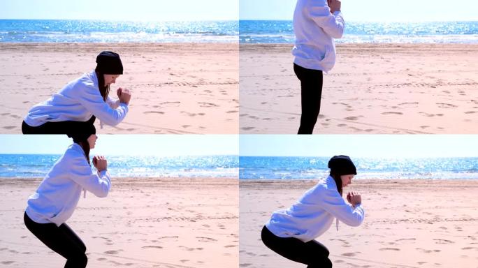 女孩在沙滩上做蹲坐健身户外运动训练。
