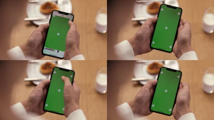 餐桌前手触绿色抠像手机屏幕
