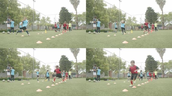 坚定的男孩和女孩在野外练习足球训练