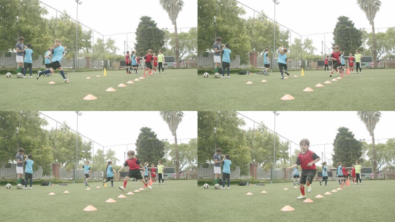 坚定的男孩和女孩在野外练习足球训练