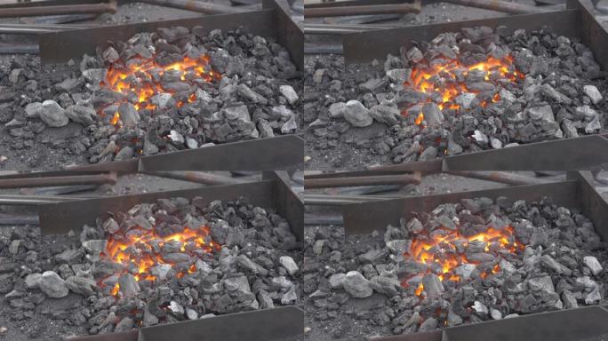 余烬在铁炉中发光。锻造用铁件的退火和热处理。