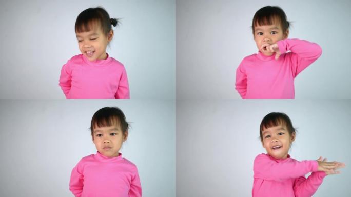 一个快乐微笑的亚洲儿童女孩的肖像，孤立在白色背景上。