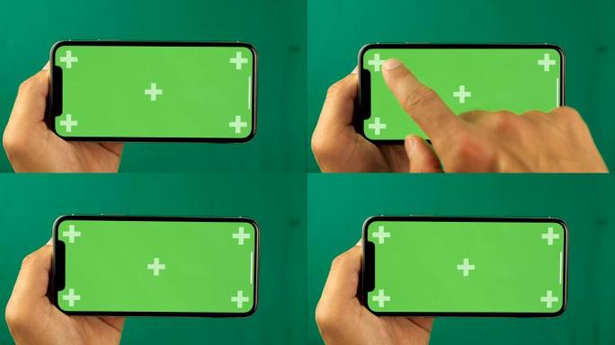 男性手触摸智能手机的特写。绿屏色度键。手机屏幕是绿色色度键，背景是另一个色度键绿色屏幕。移动广告素材