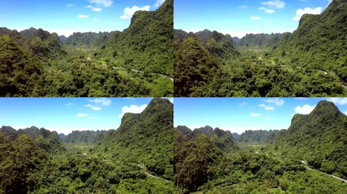 相机在山脚下的山谷和道路上方升起