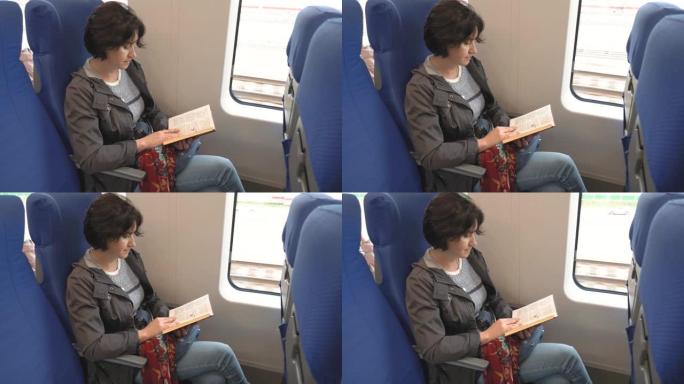 高加索中年黑发女人坐在火车上看书
