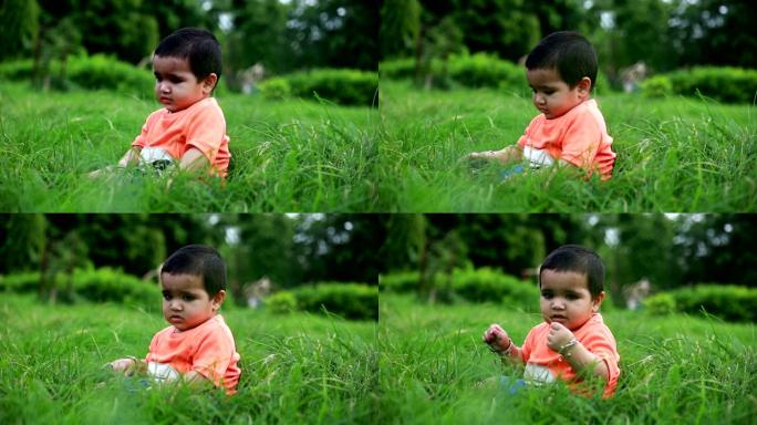 无辜的女婴在草地上玩耍