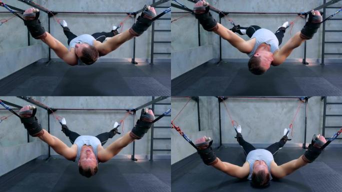 运动员做运动使用教练在健身房的空气中伸展肌筋膜。