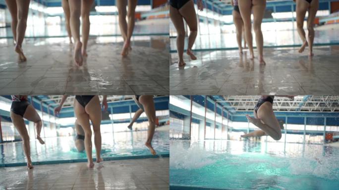 女游泳者跳入游泳池