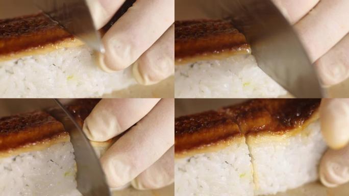 用刀切寿司卷米饭和熏鳗鱼的特写镜头。